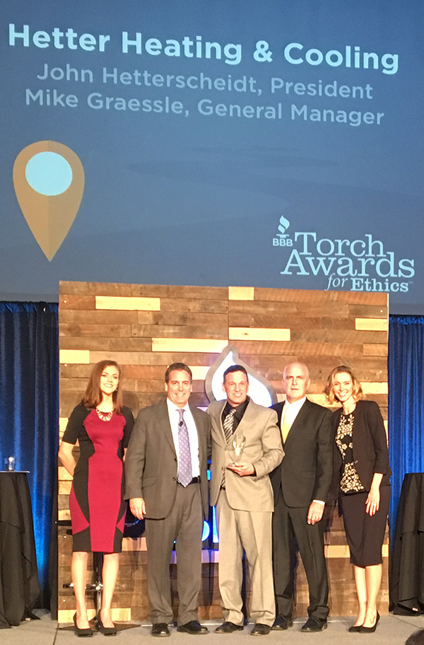 Pictured are Hetter president & owner John Hetterscheidt (middle) and Hetter GM Mike Graessle (second from right) accepting the 2016 Torch Award from Kip Morse (second from left), president of the central Ohio chapter of the Better Business Bureau. 